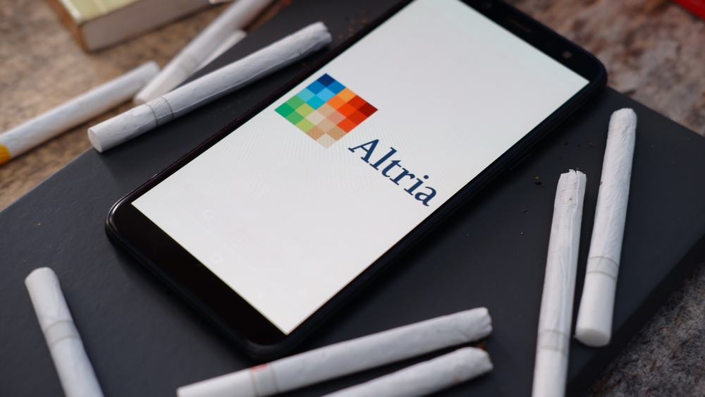 Consumer Defensive - Altria Group Inc_ cigarettes and logo -by Poetra_RH via Shutterstock